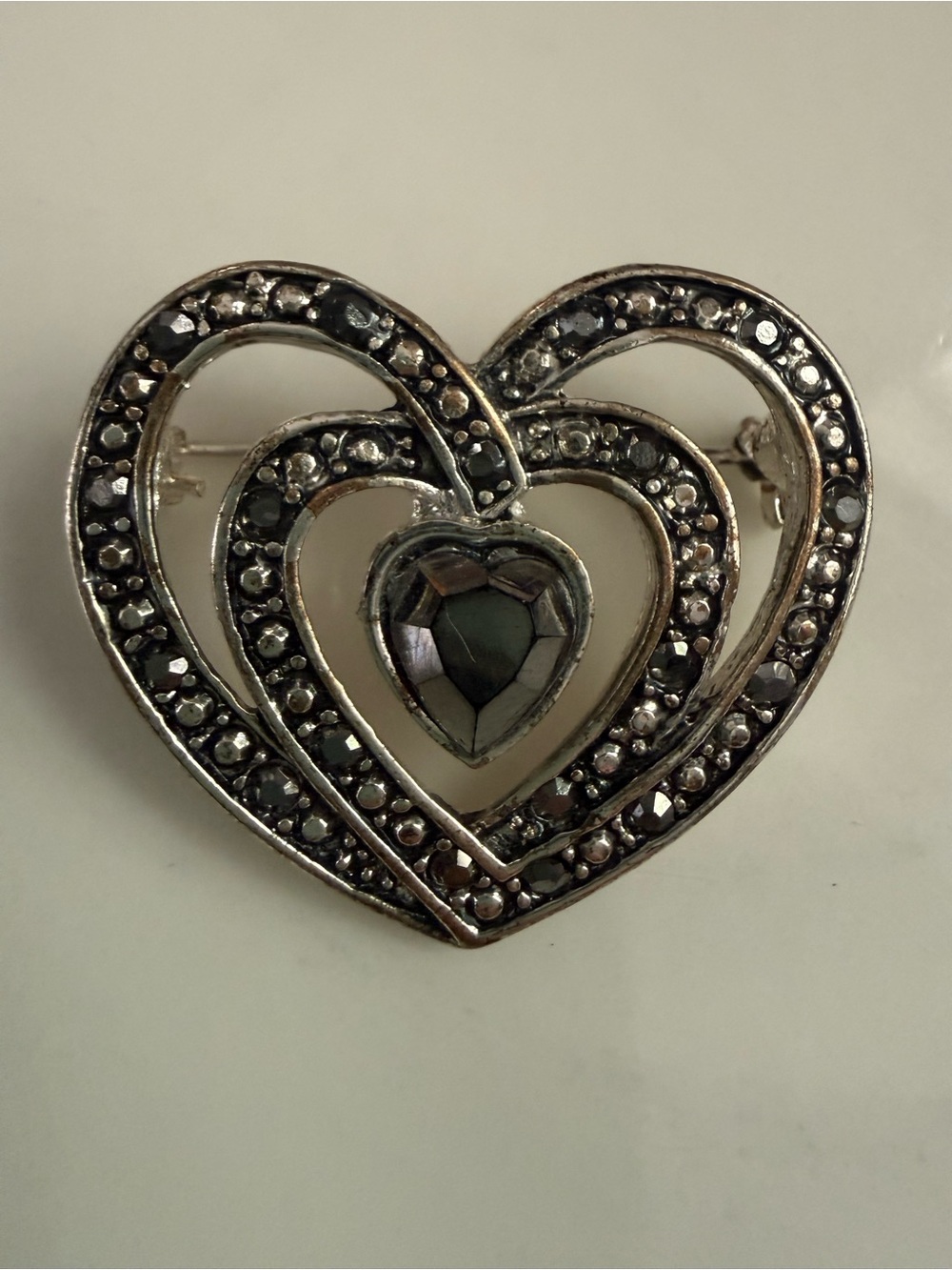 Vintage rhinestone Heart shape silvertone Filigree Brooch with gray/black Stones